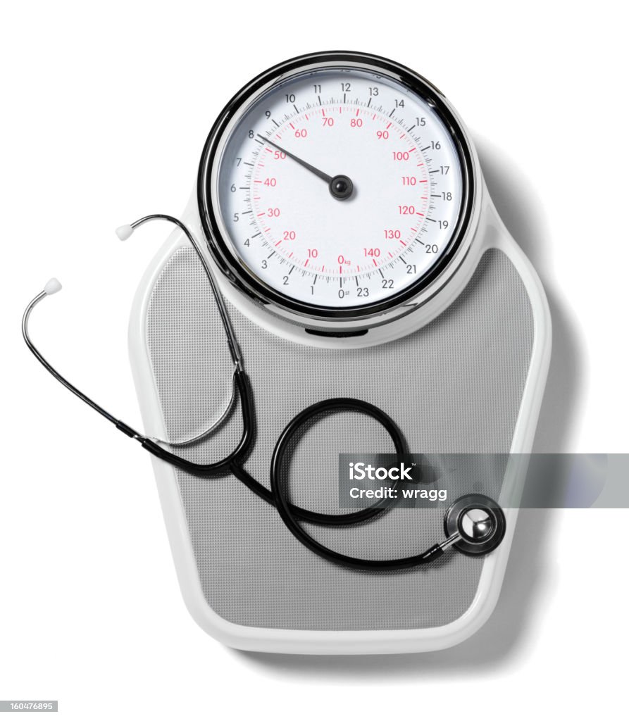 Stethoscope on Bathroom Sacles Stethoscope on bathroom scales, isolated on white with clipping path. Balance Stock Photo