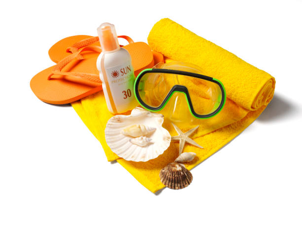 Flip flops, snorkel  mask and beach towel with sun protection  Isolated on white with clipping path.