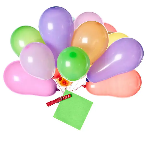 Bunch of balloons with a note pinned to the knot with a peg on white background