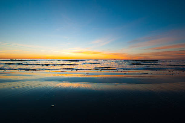 Color just before sunrise Photograph of a beach in Georgia just before the sun crests the horizon. saint simons island photos stock pictures, royalty-free photos & images