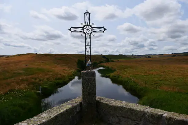 The cross on a bridge over the Bès river, surroundings of Marchastel on the Aubrac plateau, Lozère
