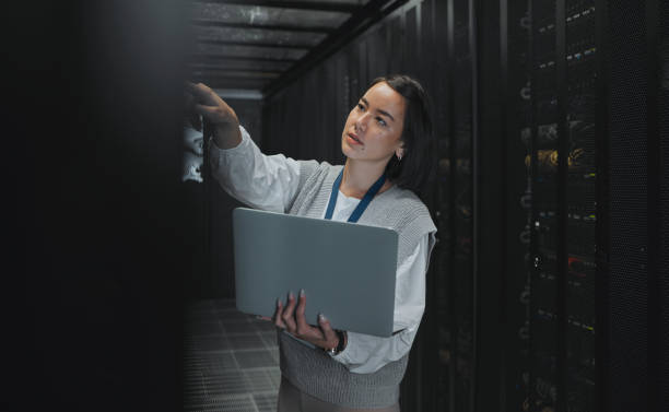 istock Laptop, maintenance or IT woman in server room for research, engineer working in data center. Computer, cybersecurity and girl programmer with tech for problem solving, diagnose or troubleshooting 1604798812