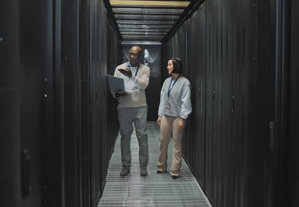 istock Server room, teamwork or people on laptop for software management, system upgrade or cyber security. Network technician, engineer or programmer staff on tech for information technology or programming 1604798814