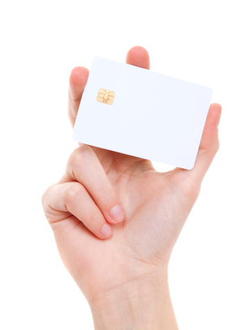 Close up of woman's hand holding blank white prepaid card. Studio shot isolated on white.