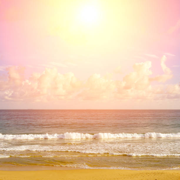 Fantastic sunset over ocean, sea waves and sand.