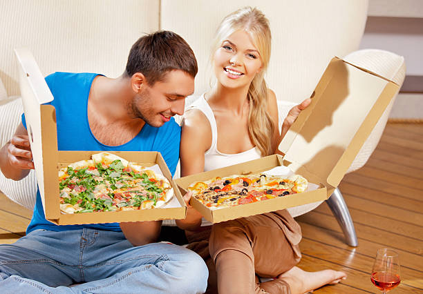 istock romantic couple eating pizza at home 160480214