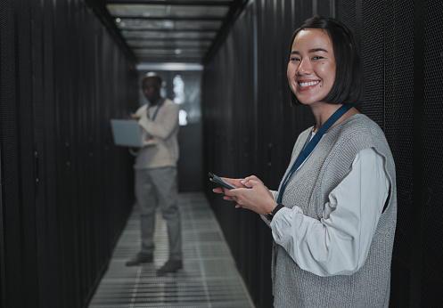 Technician, woman and portrait with phone in server room for digital management, coding and tech. Female engineering, mobile technology and data center for programming, cyber administration and smile