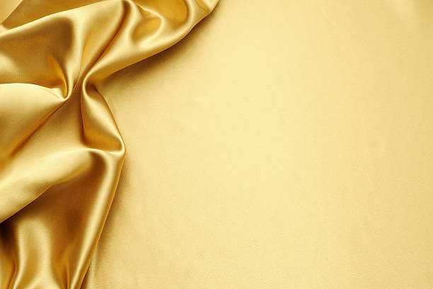 Gold satin texture background with copy space Close-up shot of gold satin texture backgrounds with copy space. mustard yellow fabric stock pictures, royalty-free photos & images