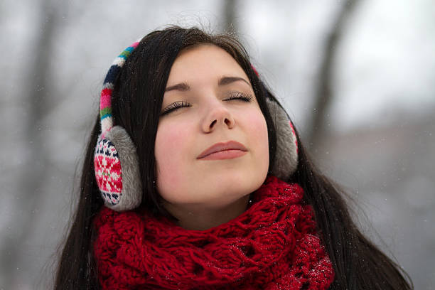 istock Girl wearing earplugs outdoors in winter 160481583