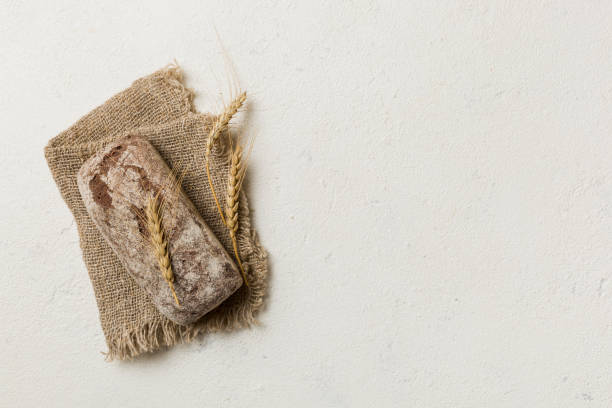 Fresh rye bread on napkin on rustic background, fresh bread top view
