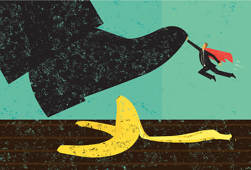 A miniature, super businessman saves someone from slipping on a banana peel. The shoe, man, and banana peel are on a separately labeled layer from the background.