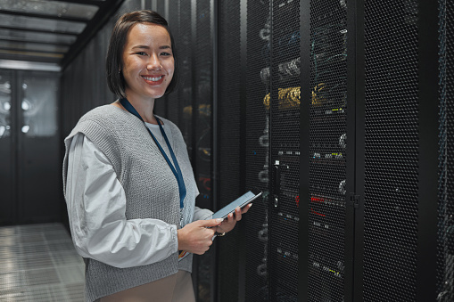 Asian woman, portrait and tablet of technician by server for networking, maintenance or systems at office. Happy female engineer smile for cable service, power or data administration or management