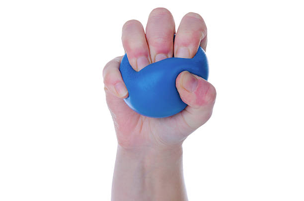 Squeezing stress ball stock photo