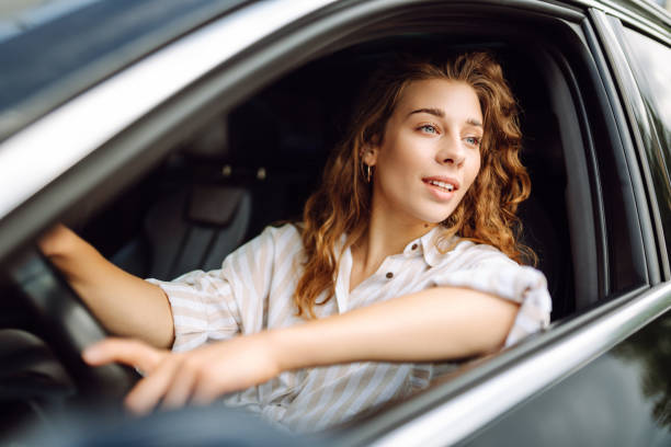 istock Beautiful smiling woman driving a car. 1604840878