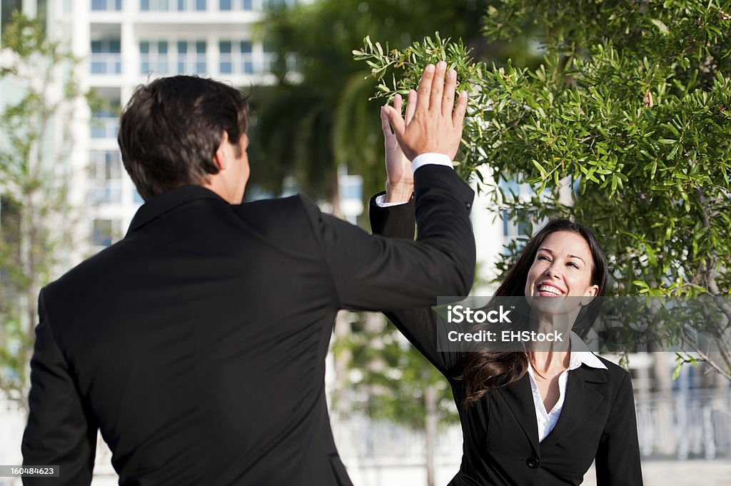 Businessman and Businesswoman High Five - Foto de stock de Adulto libre de derechos