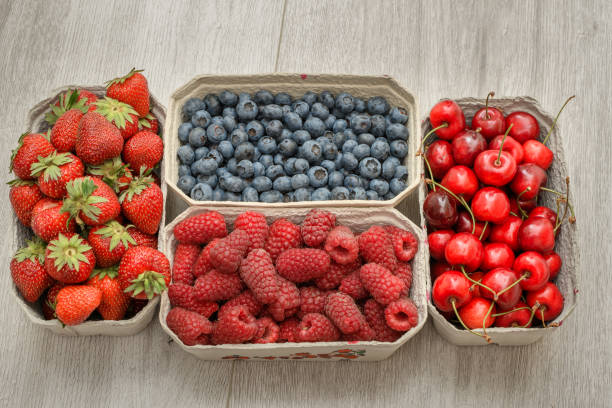 istock Fresh strawberries, cherries, blueberries and raspberries in ecological containers 1604856785