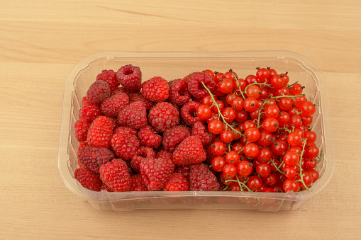Red fruits in a plastic container