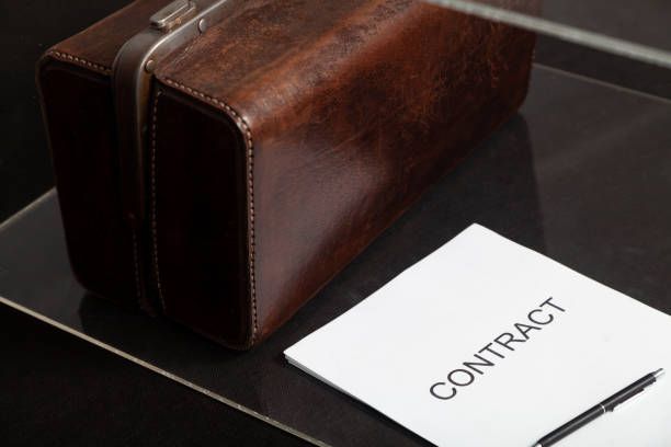 istock Contract and leather carpetbag close-up 1604867411