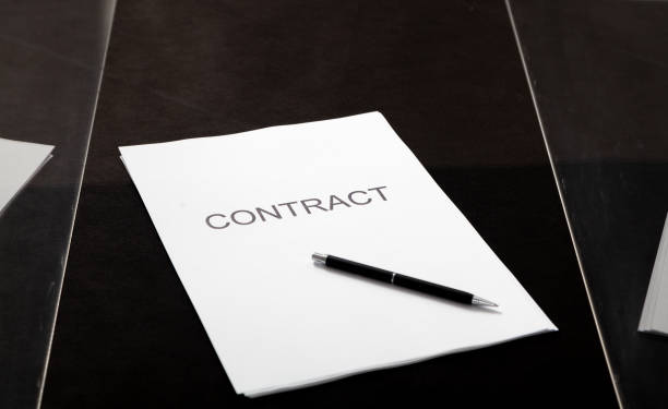 istock Contract and pen lie in transparent box 1604867413
