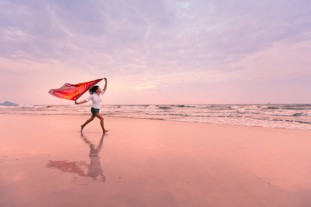 istock Woman on windy beach 160487473