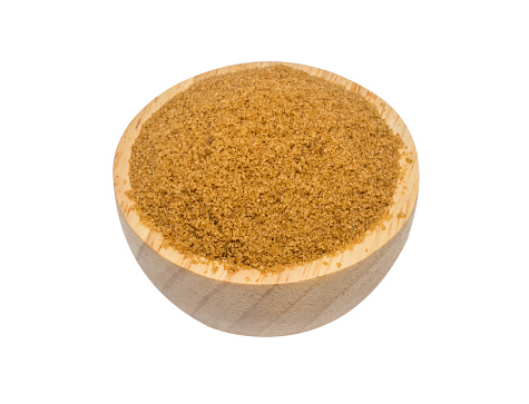 isolate white background of brown sugar in a wooden bowl