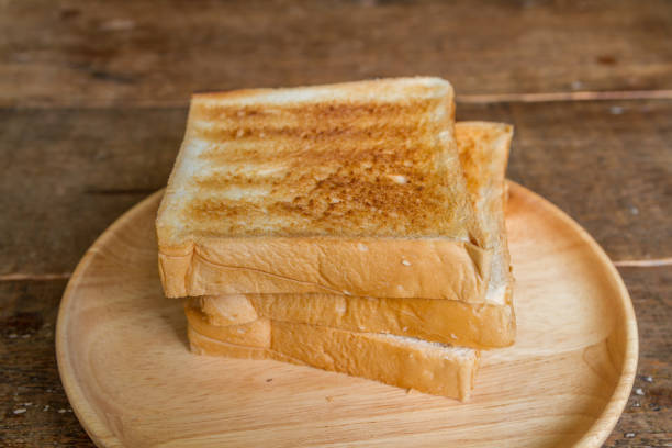 grill fresh bread slice on a round wooden dish