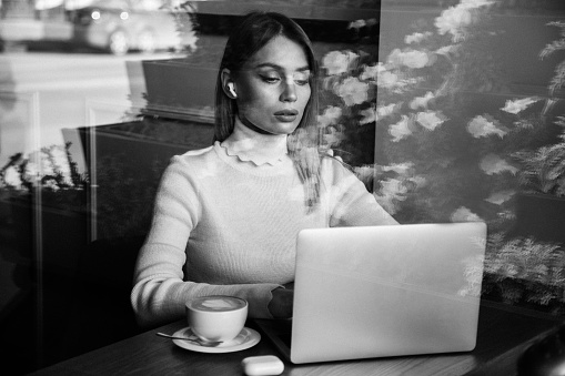 Beautiful woman holding laptop. Black and white photo