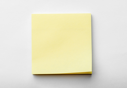 blank pastel yellow sticky notes packaging on white background. Discussing business, teamwork, brainstorming concept. sticky notes paper with shadow. copy space