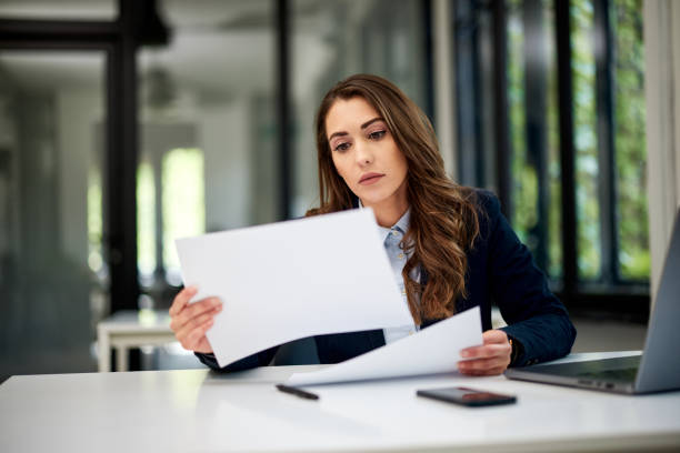 istock A hardworking businesswoman doing paperwork while sitting at the office. 1604910870