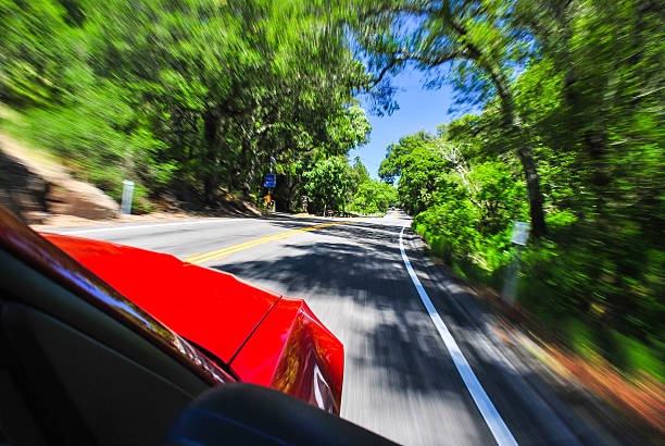 Red Sports Car Flying Down the Road with Blurred Motion stock photo