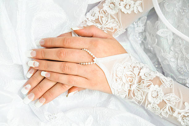 istock bride holding the hands on a white wedding dress 160492167
