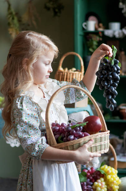girl with long blond hair with a grape harvest in her hands