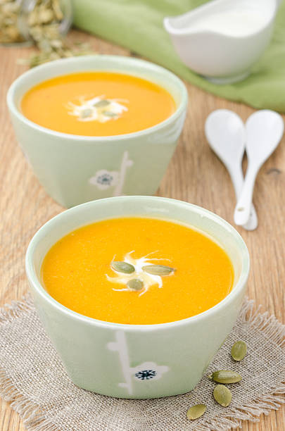 istock two bowls of pumpkin soup with ginger 160493613
