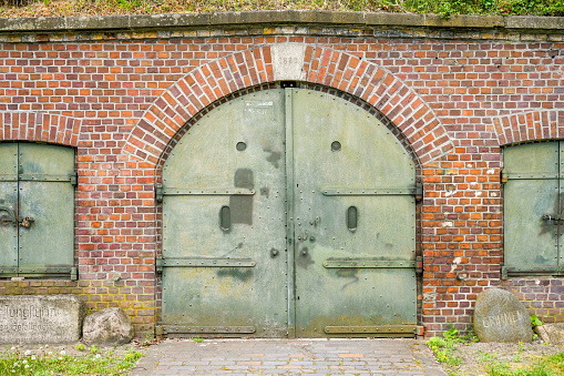 Swinoujscie Fortress. Entrance with an old gate on a part of the building.