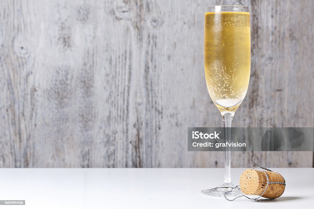 Champagne glass and cork Champagne glass and cork in backround painted wood Alcohol - Drink Stock Photo