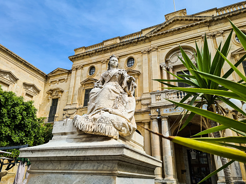 Valletta, Malta - May 12, 2023: The statue of Queen Victoria on the Republic square in front of the National Library of Malta  in Valletta in Malta.