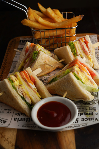 Food photography of a club sandwich and chips at a restaurant