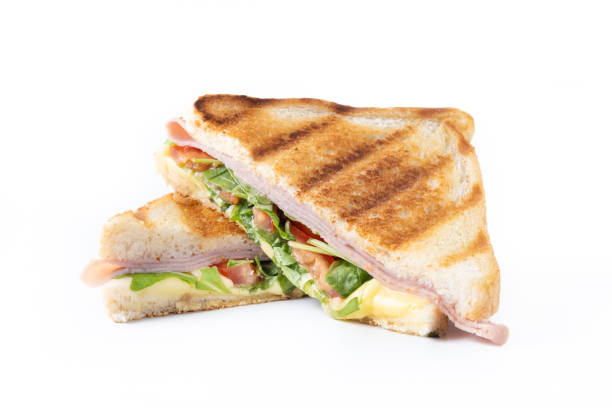 istock Panini sandwich with ham, cheese, tomato and arugula isolated on white background 1604957180
