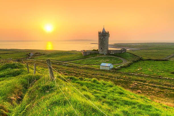 Coast of Co. Clare at sunset in Ireland Acient tower on the coast of Co. Clare at sunset, Ireland county clare stock pictures, royalty-free photos & images