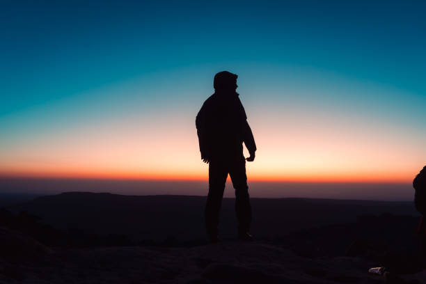 istock Silhouette of man at sunrise 1604996801