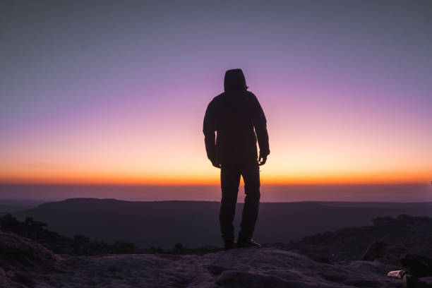 istock Silhouette of man at sunrise 1604996804