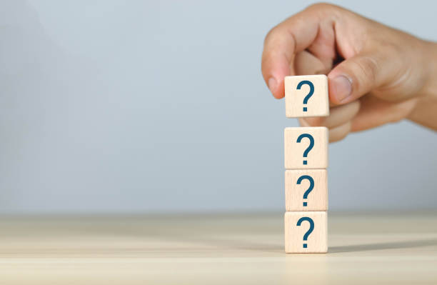istock Hand holding a marker on a wooden block on a table 1604998414