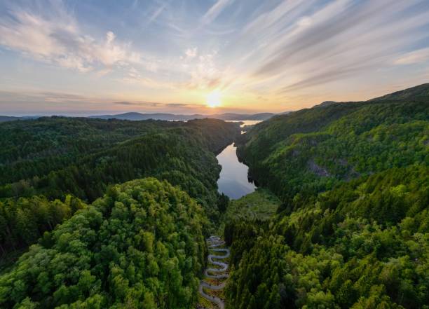 istock a beautiful view of the sun setting over trees and river 1604998417