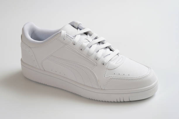 istock White shoes on a light background close-up. 1605001710
