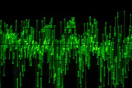 Audio signal on oscilloscope screen. Communication and electronics. Close up, blurred focus