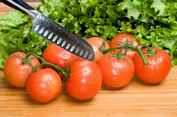 Cut tomato on  board.Fresh vegetable