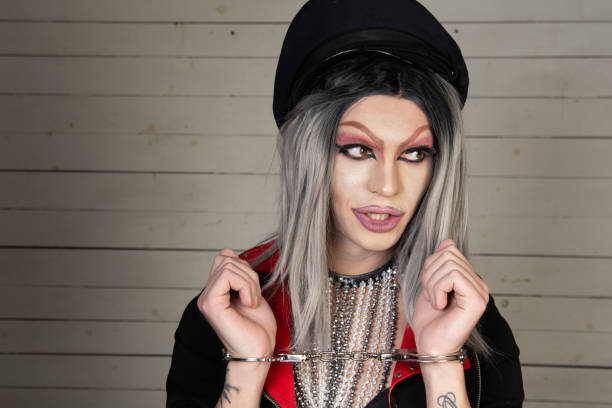 istock Drag queen in a provocative outfit poses in the studio. 1605024031