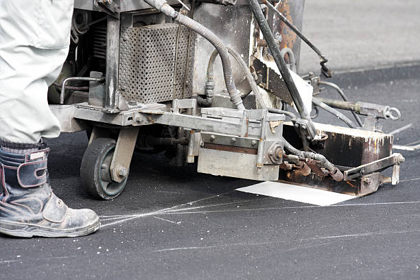 istock Road worker makes a line on new asphalt 160503354