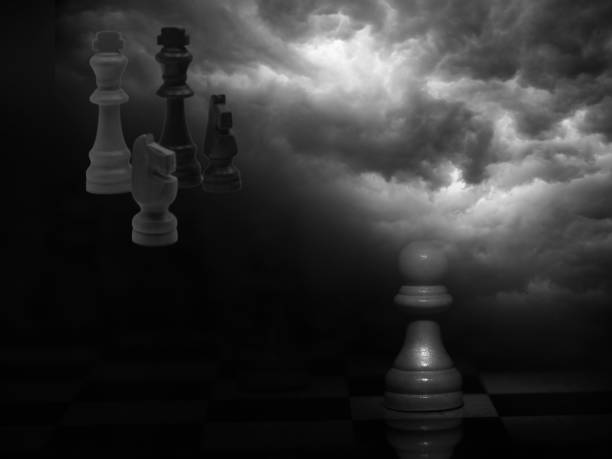 istock Hand on chessboard and pieces flying. Cloudy background 1605037828