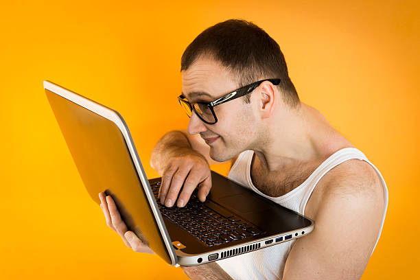 istock Visually impaired Nerd guy in sleeveless shirt working on laptop 160503824